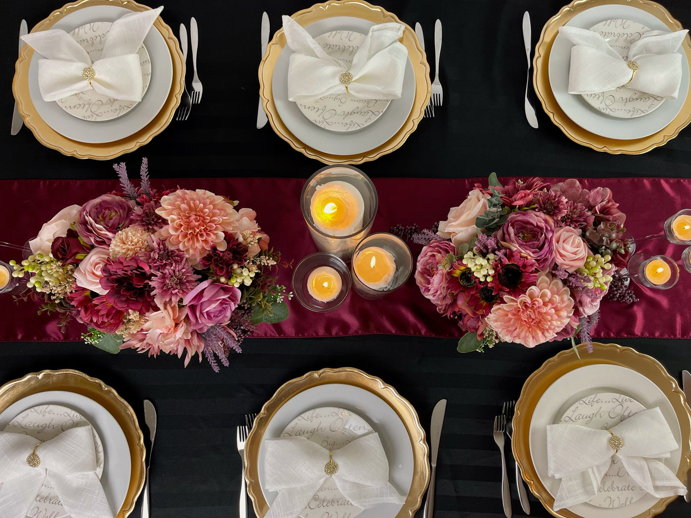  Ornate gold chargers shown on black tablecloth with with white napkins and gold napkin rings