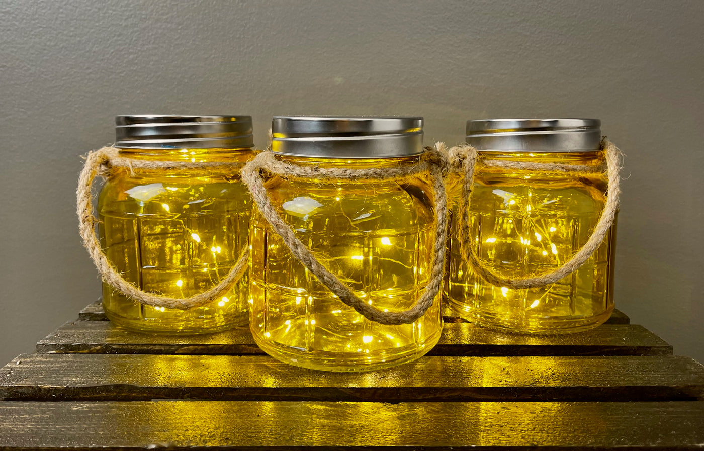 Six inch tall x 5 inch wide yellow mason jars equipped with fairy lights. Rent for $2.00 each.
