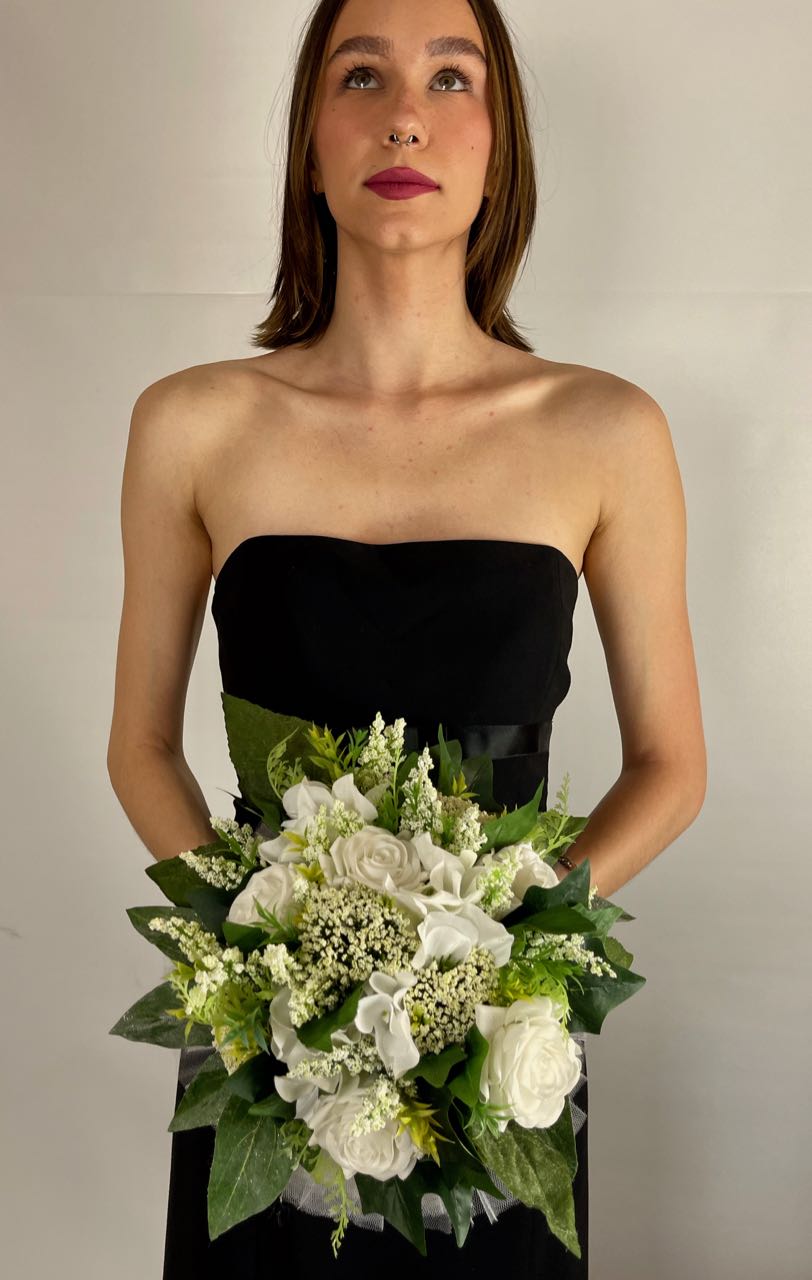 This crisp white bridesmaid bouquet combines white roses, astilbe and dark green ivy to create a simple elegant bouquet. It is finished off with a wispy white tulle base and a white satin wrapped handle. This bouquet rents for five days for $59.00