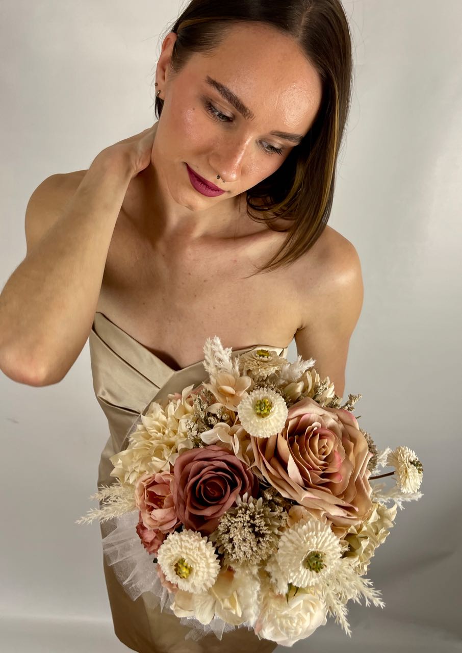 Rent a Rose 's  Cappuccino Blush collection bridesmaid bouquet skillfully blends blush pink, cream and cappuccino roses with cream pampas and the playful pop of mini beige pompom dahlias.  Rent for five days for $59.00