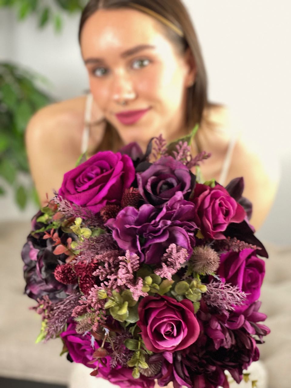 This stunning bridal bouquet merges the freshness of magenta roses with the regal presence of purple hydrangea and black orchids, all elegantly offset by the luxuriant shades of plum, deep green eucalyptus sprigs, and burgundy thistle. Expertly crafted into a hand-tied bouquet and finished with sumptuous amethyst satin ribbon, this statement piece is the perfect complement for your bridal ensemble. Rent for Five days for $88.00