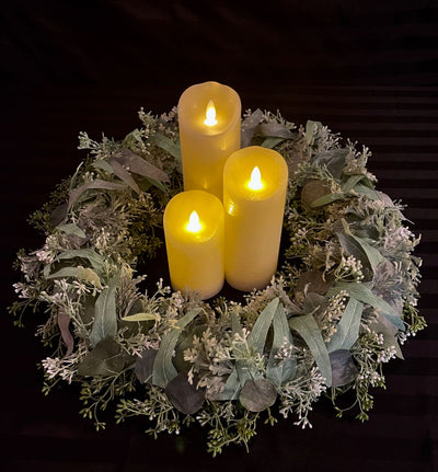 This uncomplicated centrepiece is perfect or for those that appreciate the simplicity of a monochromatic eucalyptus design combined with cream pillar candles. Select the number of LED pillar candles you would like to complete this look. The outer circumference of this wreath is 21 inches and in inner circumference is 10 inches. Pillar candles to be rented separately Each pillar candle is an additional $3.00 to $4.00 to rent.