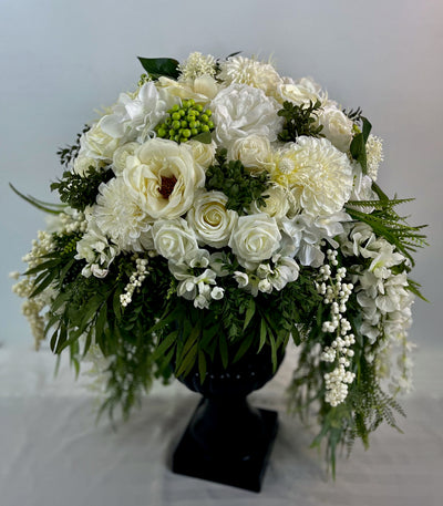 Three foot tall black urn with cascading white flowers and greenery