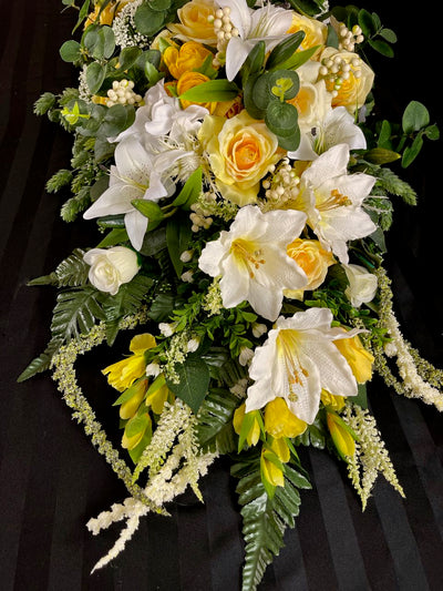 Bring a touch of nature indoors with this breathtaking floral design.  We have combined dark green eucalyptus with cream dahlias, white lilies, yellow & white roses, crisp snow white hydrangeas accented with white hypericum berries, thistle and trailing amaranth. This gorgeous floral piece measures four feet long and 16 inches wide