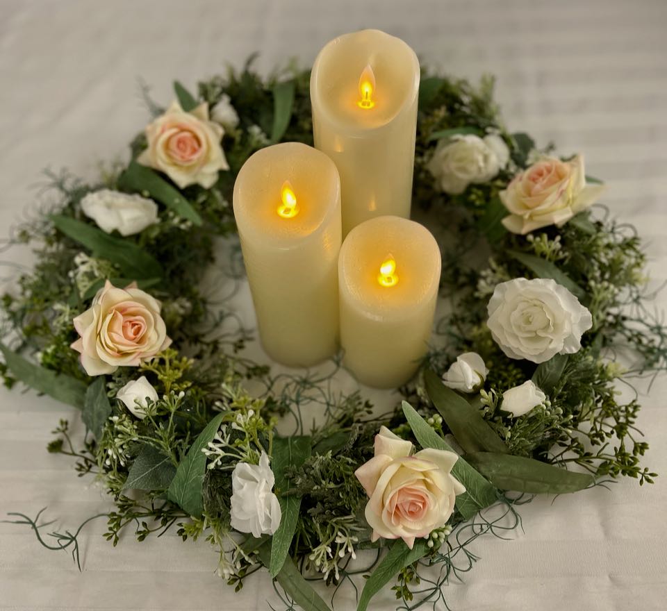 Eucalyptus Candle Ring. Meticulously crafted with five types of sage eucalyptus, four blush roses and a splash of mini white roses, its 21-inch circumference and 10-inch inner circumference combine stately beauty with a luxurious feel.