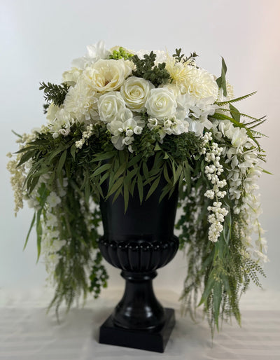 Three foot tall black urn with cascading white flowers and greenery