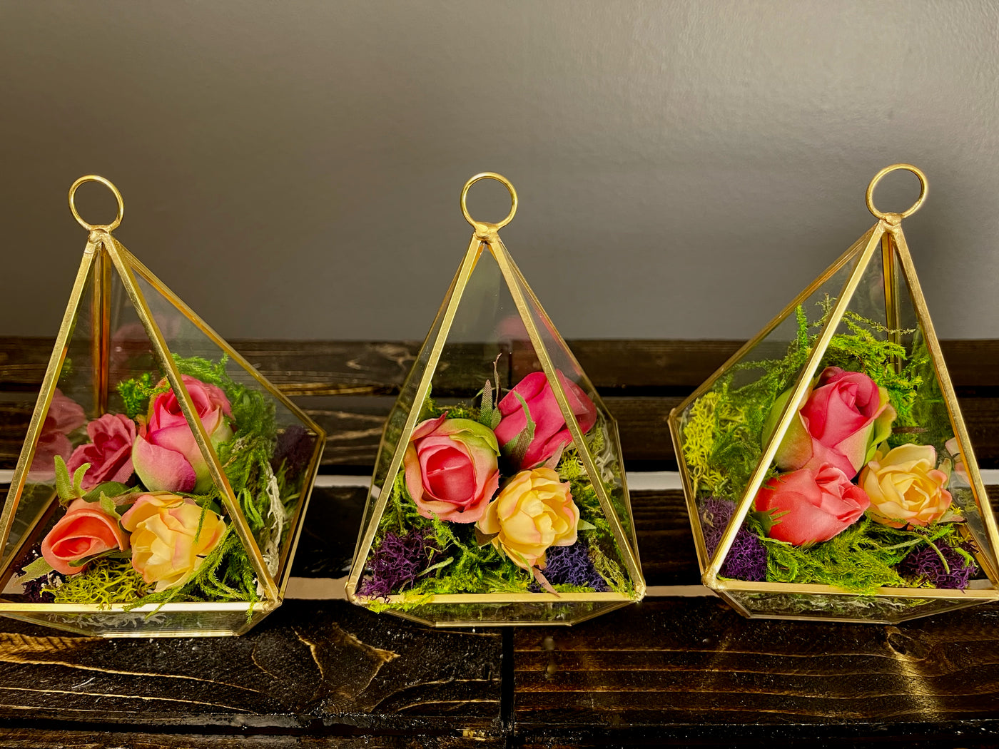The golden pyramid trio will add dimension to your event with the formal lines of the gold geometrical pyramid, juxtaposed with the soft natural shapes of the moss and floral terrarium.   Small Pyramid L5.5", W3"