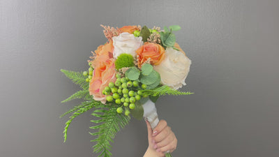 Rent a Rose-Bridesmaid Bouquet-  Cream and Orange flowers with Green accent berries- rent for five days for $69.00.