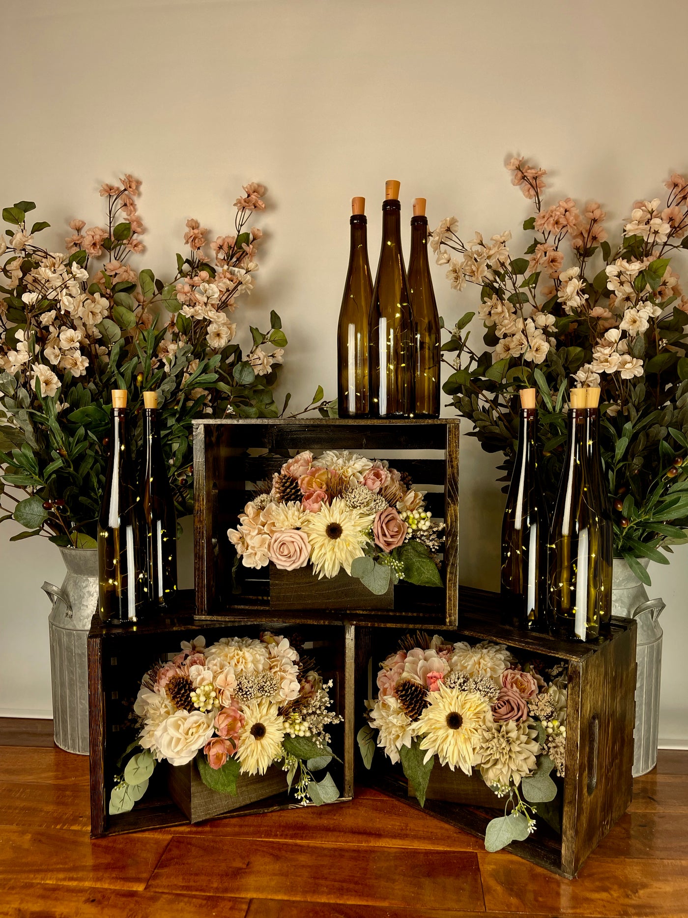 These two galvanized steel milk containers can come filled with either eucalyptus accompanied by small beige and pale pink flowers, or eucalyptus alone. Containers are 15" tall, and with the florals are 36" tall.