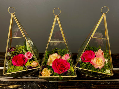 The golden pyramid trio will add dimension to your event with the formal lines of the gold geometrical pyramid, juxtaposed with the soft natural shapes of the moss and floral terrarium.   Large Pyramid L9.5", W5"
