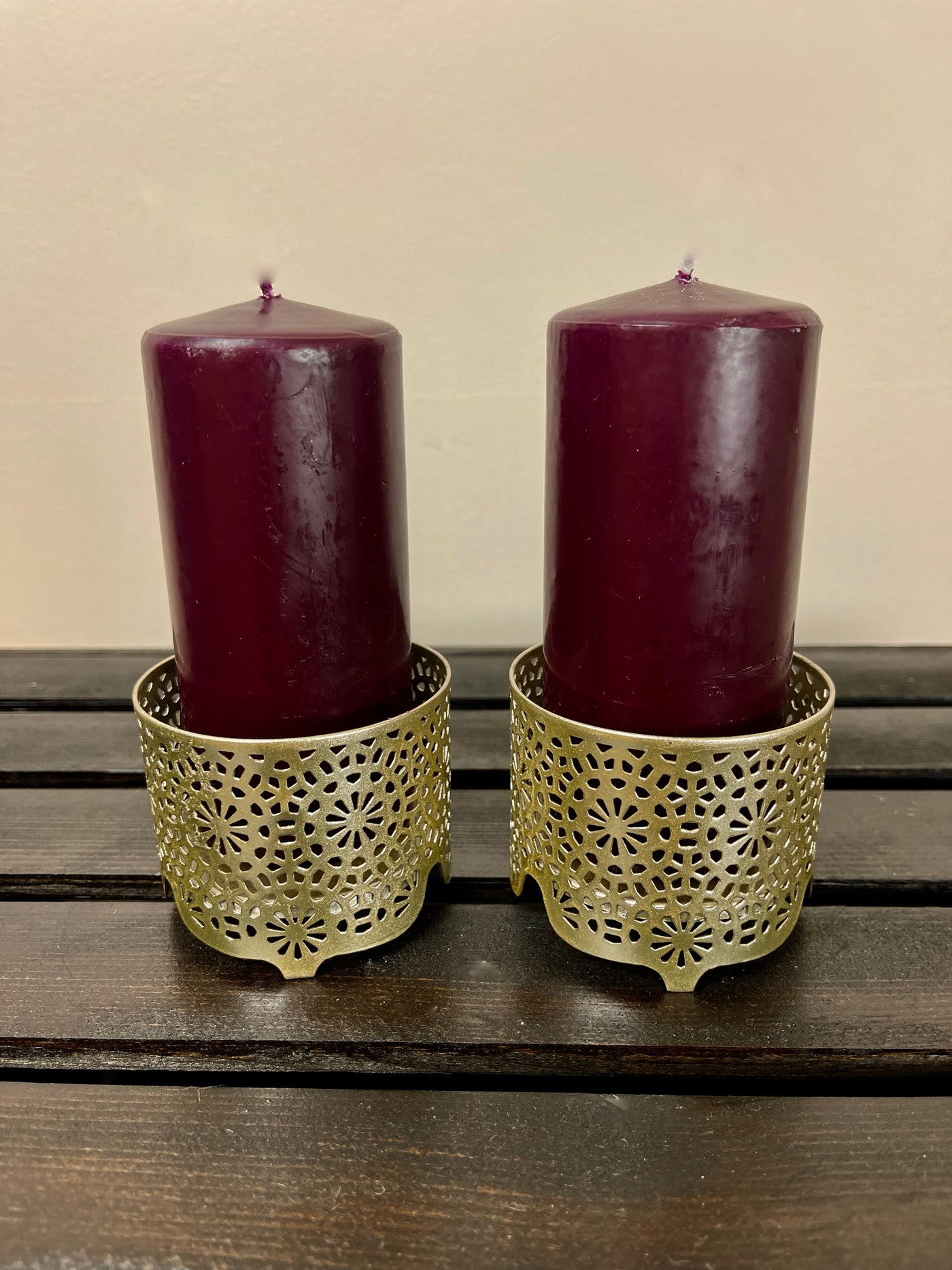 This gold finely detailed candle holders give off a cool Moroccan vibe. They are 2 1/2 inches tall and  3 inches wide. The perfect sized candle for these holders is 4 1/2 inches tall by 2 inches tall.  We  can source candles for you in any colour upon request. A single holder rents for $1.50 each.