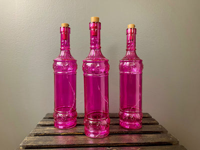 Rent a Rose- Decor Fuchsia decorate bottle filled with fairy lights.