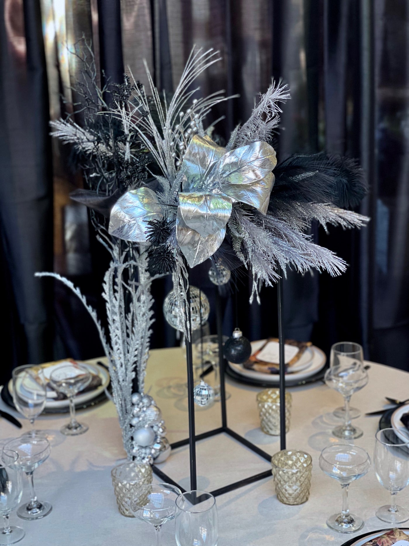 Rent a Rose- Black and silver tall rectangular centrepiece with feathers. Rent for $99.00