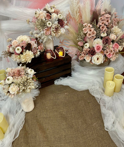 Beige and blush  florals are pictured here. Bridal and bridesmaid bouquets, centrepieces and arch florals are all featured. 