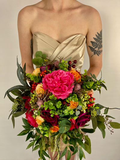 Rent a Rose-Bridesmaid Bouquet- Jewel toned rich colors of Burgundy orange, fuchsia make up this oversized bouquet.Rent for five days for $69.00