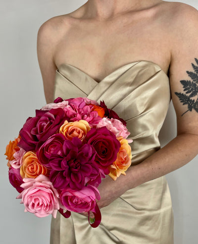 Rent a Rose-Compact Colorful  Bridal Bouquet in Fuchsia and orange. Availabe to rent for three weeks. Especially designed for tropical destination weddings.