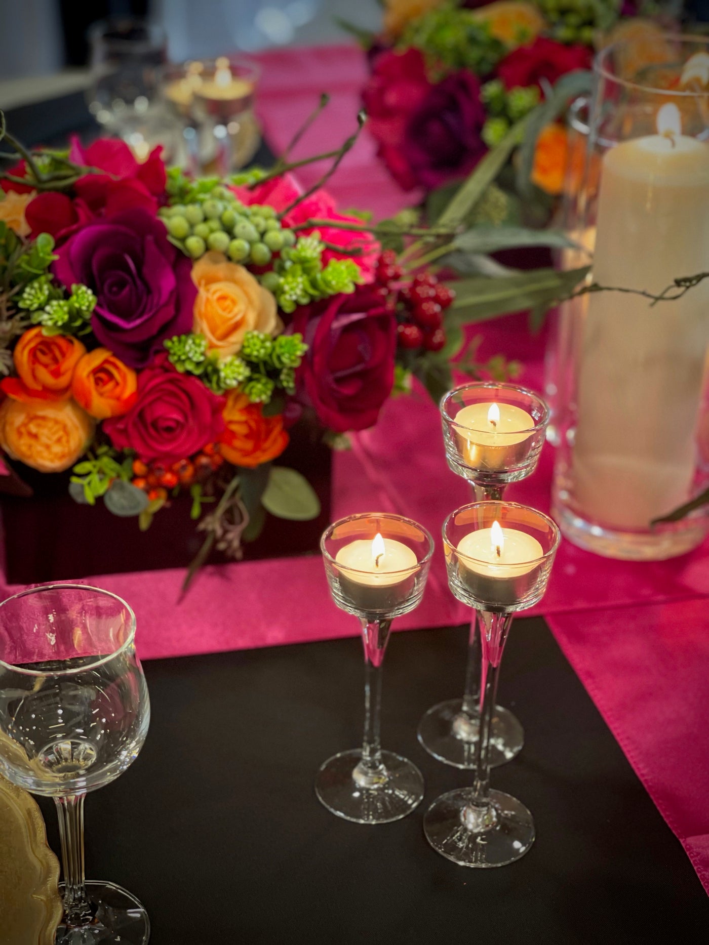 Rent a Rose- Centrepiece- Orange, Burgundy, and Fuchsia- flowers with Olive green berries rent for five days for $20.00