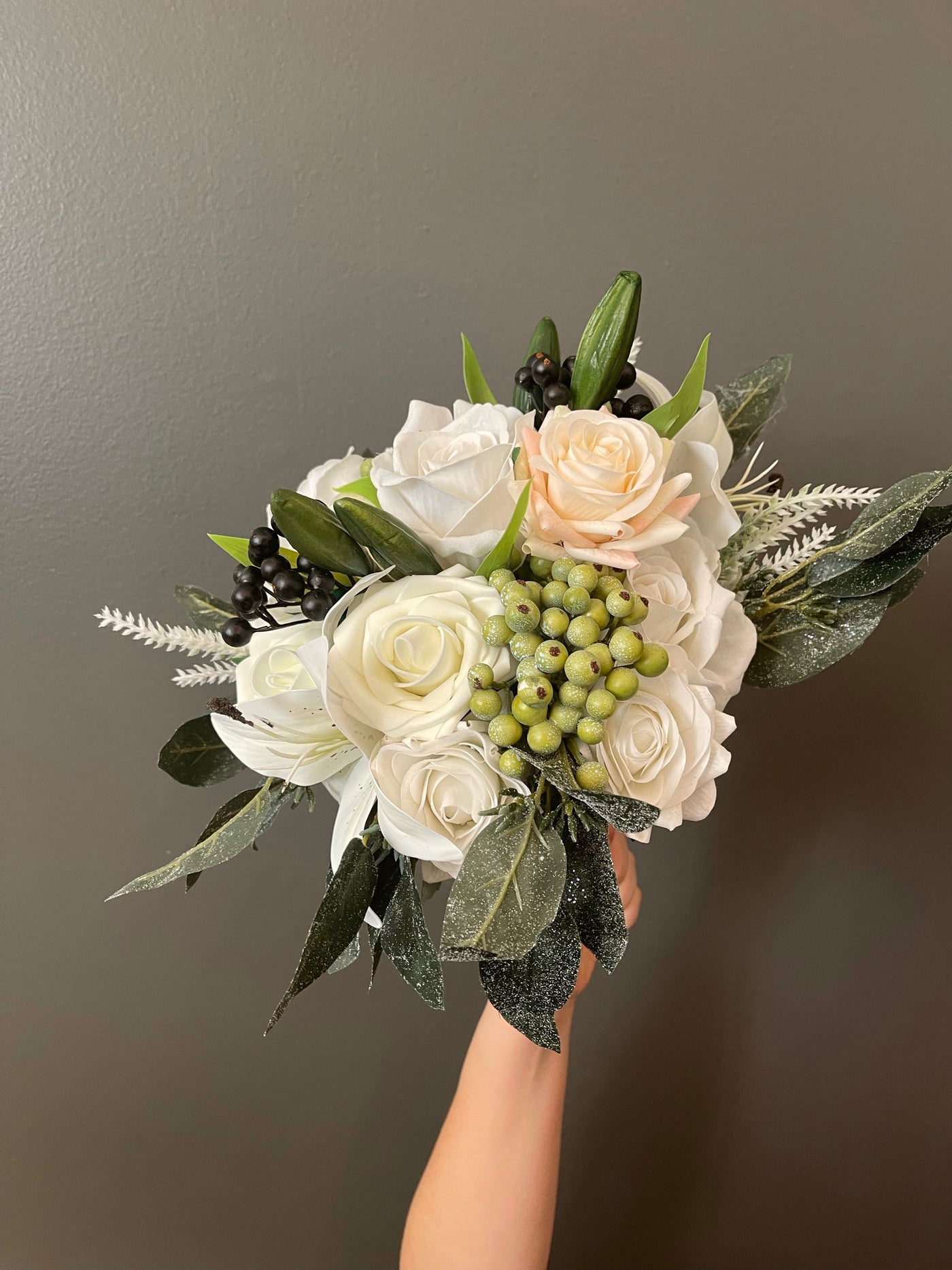 Rent  A Rose- Flower Girl Bouquet- white lilies and roses accented with black and olive green berries. Rent for five days for $35.00