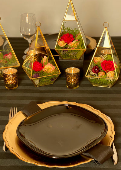 The golden terrarium trio (1 Lrg, 2 Sm) will add dimension to your event with the formal lines of the gold geometrical pyramid, juxtaposed with the soft natural shapes of the moss and florals. These would be great on high top cocktail tables.    Large Pyramid -9.5"tall x 5" wide  Small Pyramid - 5.5" tall x 3" wide