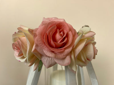 Close up of faux rose attached to the top of Hurrican lamps to show how realistic the blooms look